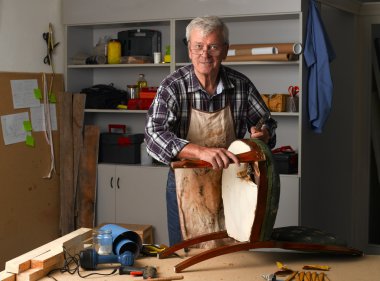 retired man standing at his workshop