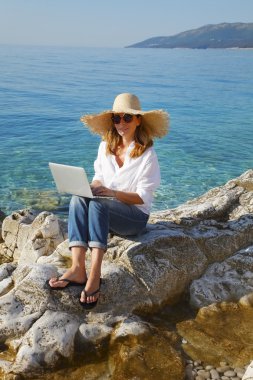 businesswoman sittiing by with laptop