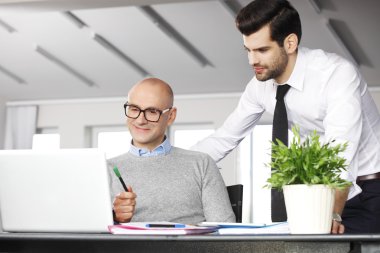 senior businessman consulting with financial assistant