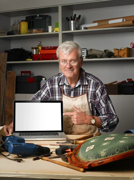 Senior bicycle repair shop owner — Stock Photo, Image