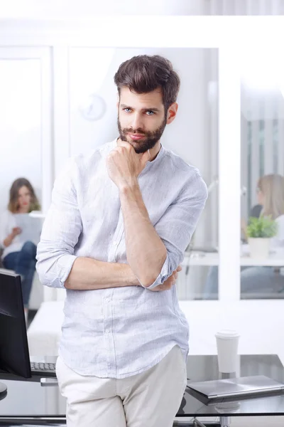 Young professional standing in office — Stock Photo, Image