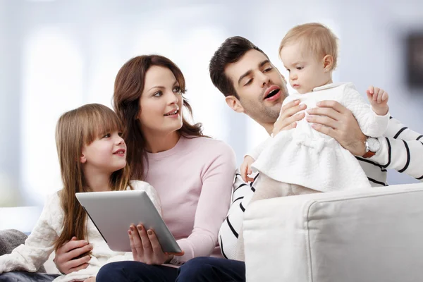 Happy family watching at tablet — Stok fotoğraf