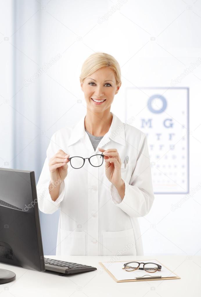 female doctor holding eyewear