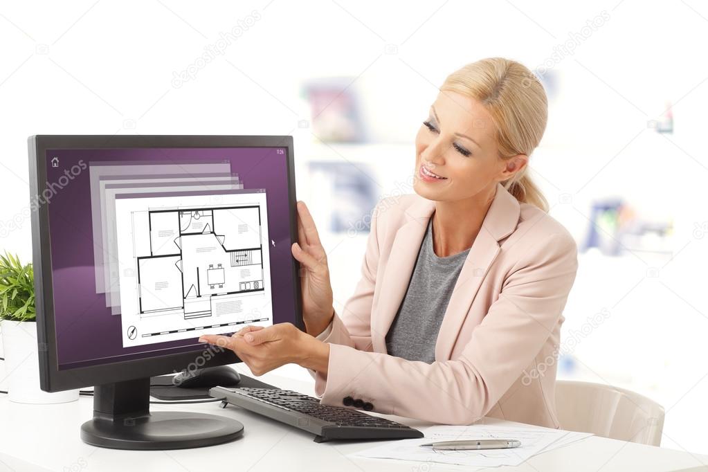 estate agent at office in front of computer