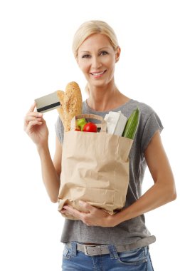 woman holding shopping paper bag full of food