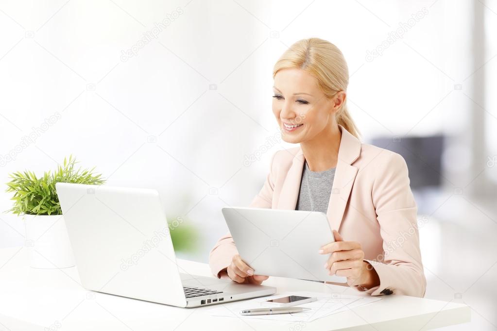 Businesswoman with laptop and tablet