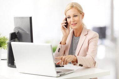 businesswoman making call while at office