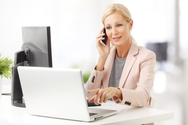 businesswoman making call while at office clipart