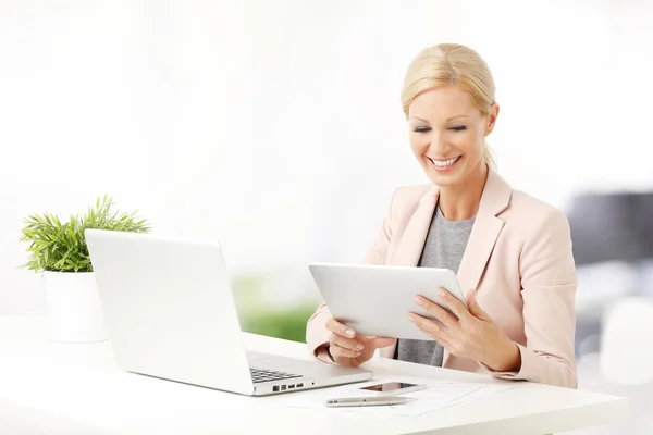 Mulher sentada no escritório na frente do laptop — Fotografia de Stock