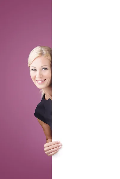 Businesswoman holding blank billboard — Stock Photo, Image