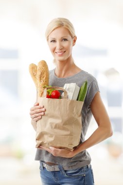 woman holding in her hand a paper bag