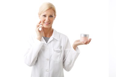 beauty specialist holding face cream jar