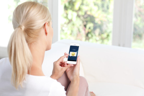 woman holding phone at living room