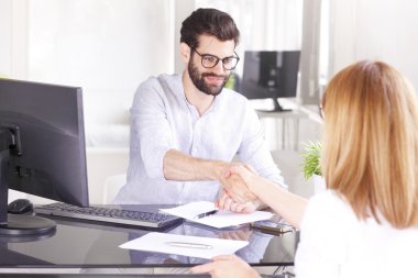 investment advisor shaking hands with businesswoman
