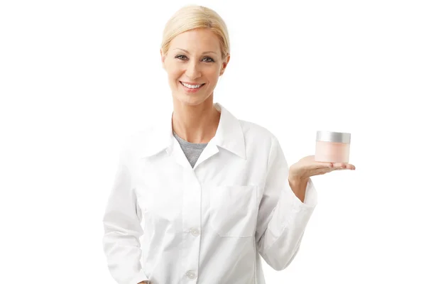 Beauty therapist holding hand jar of cream — Stok fotoğraf