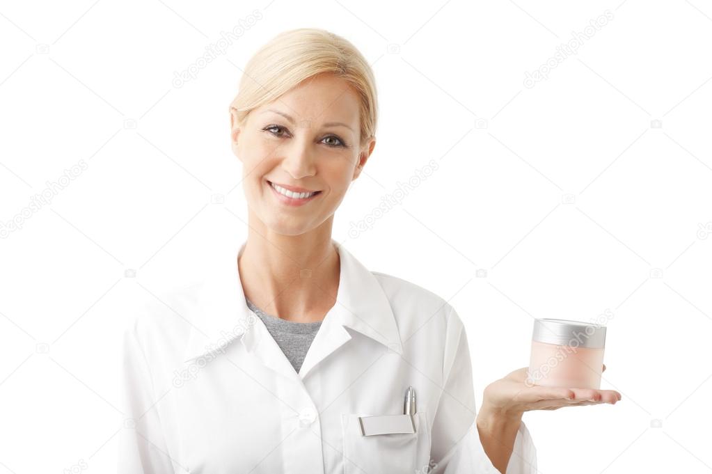 Beauty therapist holding hand jar of cream — Stock Photo © Sepy 84260988