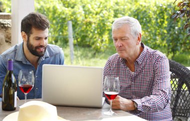 winemakers sitting in front of computer