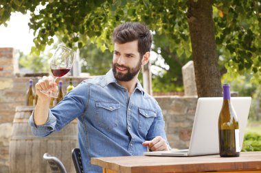 winemaker holding glass of red wine clipart