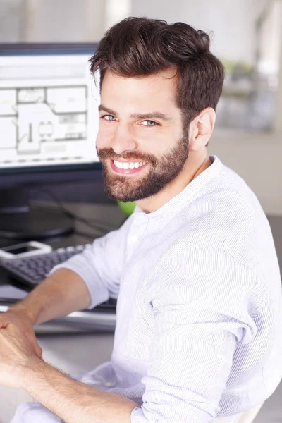 Architect sitting in front of computer — Stock Photo, Image