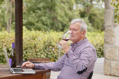 winemaker sitting at vineyard