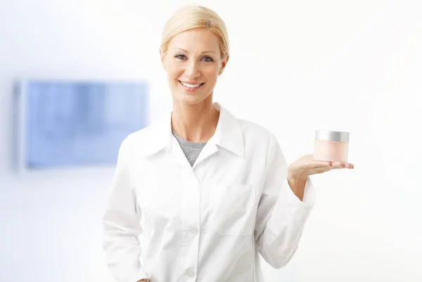 Assistant holding in her hand a jar — Stock Photo, Image
