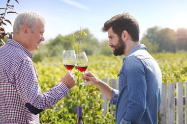 winemaker and  man holding gasses