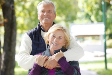 man huging beautiful elderly woman