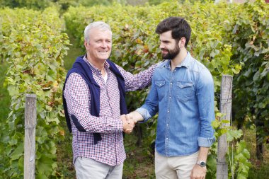 winemakers shaking hands