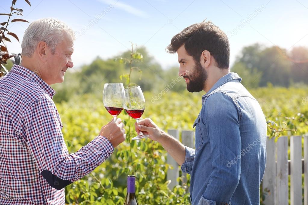 winemaker and  man holding gasses