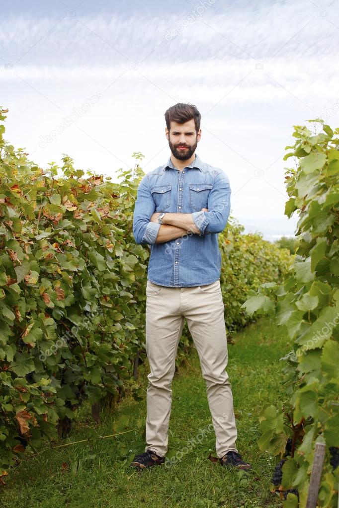winemaker standing at vineyards