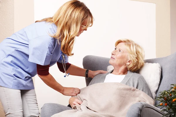 nurse caring for elderly woman