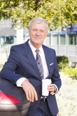 businessman  holding in hand a cup