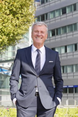 director standing in front of office building