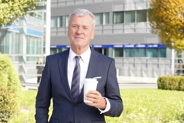 Nsurance agent holding  cup — Stock Photo, Image