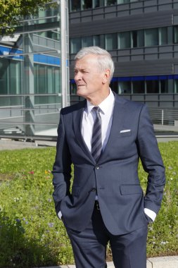 manager standing in front of  building