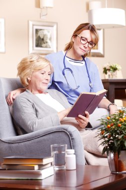 nurse sitting next to woman