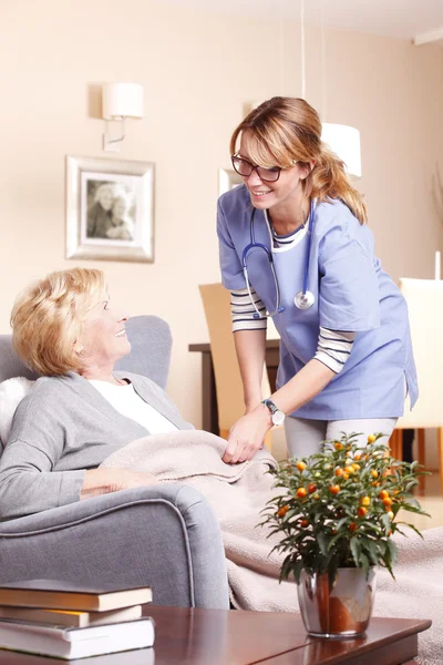 Caregiver covering woman — Stock Photo, Image