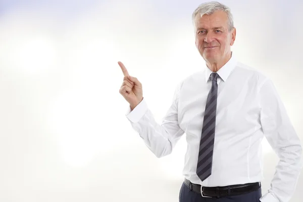 Businessman showing something with his finger — Stock Fotó