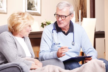 doctor consulting with elderly woman