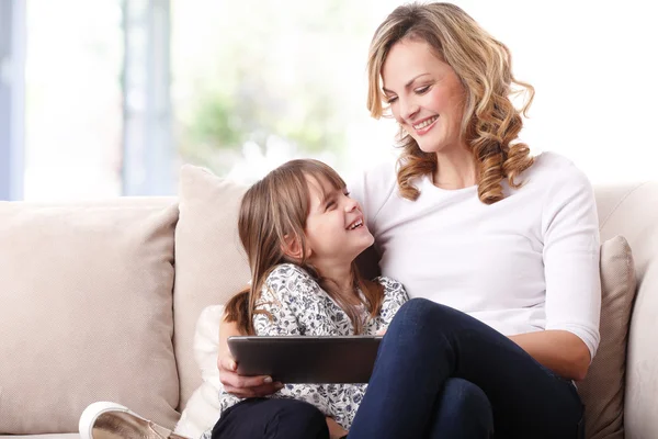 Mother and daughter watching cartoon — Stock Photo, Image