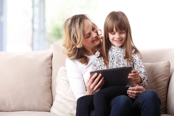 Mother and daughter using digital tablet — Stock Photo, Image
