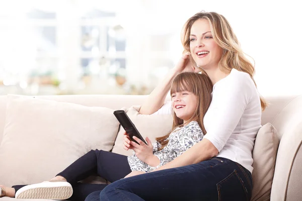 mother and daughter watching tv