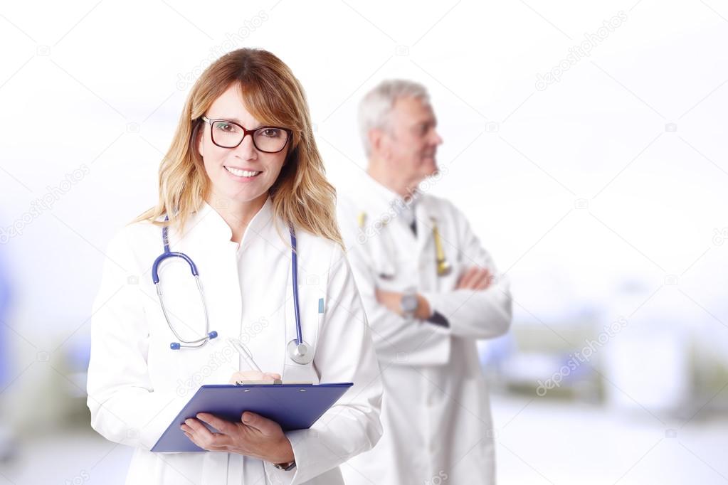 female doctor and senior doctor standing