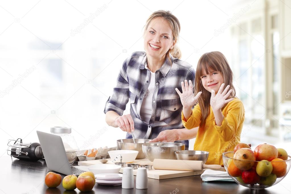 mother and  cute daughter baking