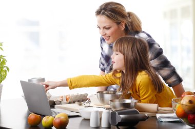 Mother and daugther using laptop