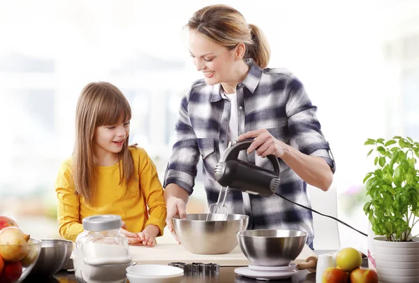Girl and her mother using mixer — Stock Photo, Image