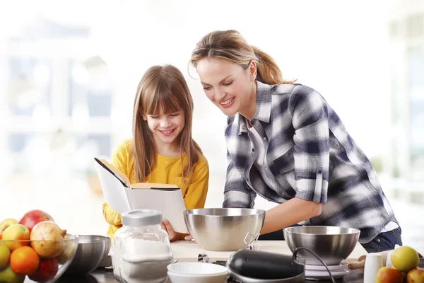 Menina segurando livro de receitas — Fotografia de Stock