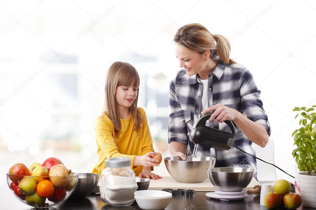 girl and her mother mixing the ingredients.