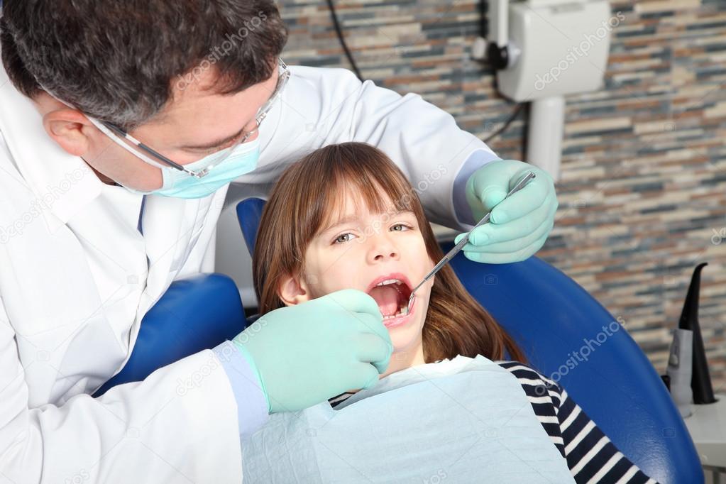 dentist is checking  patient's mouth.