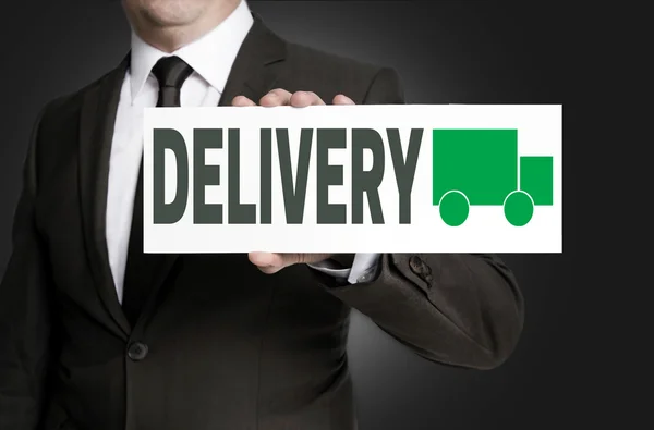 Delivery sign is held by businessman — Stock Photo, Image